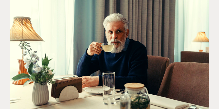 Man drink thee aan tafel